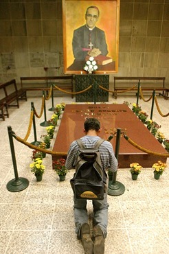 MAN PRAYS AT TOMB OF ARCHBISHOP ROMERO
