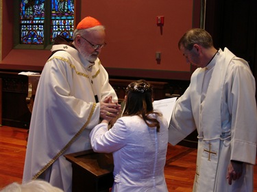 The Cardinal praying over my hands