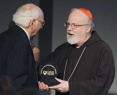 Cardinal Sean P. O'Malley awards A. Raymond Tye, president of The Ray Tye Medical Aid Foundation and Chairman Emeritus of United Liquors Ltd., the 2009 Justice and Compassion Award during the Spring Celebration 2009 at the John F. Kennedy Presidential Library and Museum, Thursday, May 21, 2009 in Boston. (Photo/Lisa Poole)