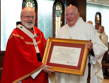 Msgr Andrew Connell receives the decree naming him Apostolic  Protonotary. Photo by Gregory L. Tracy/ The Pilot