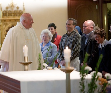 Msgr Andrew Connell receives the decree naming him Apostolic  Protonotary. Photo by Gregory L. Tracy/ The Pilot