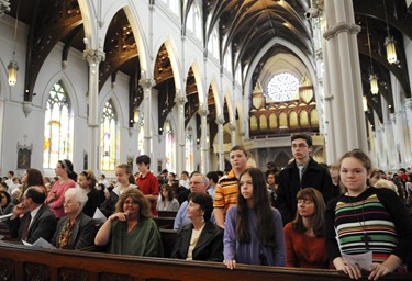 People stand to be honored during the altar server appreciation mass at the Cathedral of the Holy Cross, Boston, Saturday, Oct. 31, 2009. (Photo/Lisa Poole)