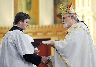 Cardinal Sean O'Malley gives William Haughey the Pope John Paul II award during an altar server appreciation mass at the Cathedral of the Holy Cross, Boston, Saturday, Oct. 31, 2009. (Photo/Lisa Poole)