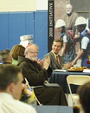 Cardinal Sean P. O'Malley claps during an awards night at the Pope John Paul II Catholic Academy in Dorchester, Wednesday, June 2, 2010. (Photo/Lisa Poole)