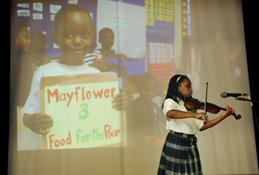 Jeanay Pierre, 10, of Randolph, MA, plays the violin during awards night at the Pope John Paul II Catholic Academy in Dorchester, Wednesday, June 2, 2010. She is a student of the Mattapan campus. (Photo/Lisa Poole)