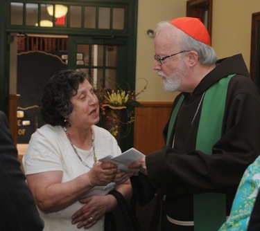 Amesbury: Cardinal Sean O'Malley speaks with a parishioner at the Newbury Parish Center at the Holy Family Church in Amesbury Saturday. Jim Vaiknoras/Staff photo