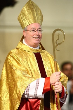 Bishop Christopher J. Coyne, a former priest of the Archdiocese of Boston, receives applause from those assembled for his ordination as the Auxiliary Bishop of Indianapolis at St. John the Evangelist Church in Indianapolis on Wednesday, March 2, 2011, after receiving his miter, crosier and Episcopal ring.  The last Auxiliary Bishop for the Archdiocese of Indianapolis was ordained in 1933.  CNS photo by Bob Nichols.