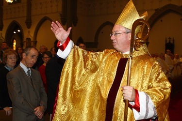 Bishop Christopher J. Coyne, a former priest of the Archdiocese of Boston, blesses those assembled for his ordination as the Auxiliary Bishop of Indianapolis at St. John the Evangelist Church in Indianapolis on Wednesday, March 2, 2011..CNS photo by Bob Nichols.