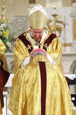 The Archbishop of Indianapolis, the Most Reverend Daniel M. Buechlein, O.S.B., lays his hands upon the head of Bishop Christopher J. Coyne, during his ordination as the Auxiliary Bishop of Indianapolis at St. John the Evangelist Church in Indianapolis on Wednesday, March 2, 2011.  The laying on of hands is a sign of the outpouring of the Holy Spirit.  CNS photo by Bob Nichols