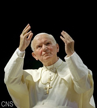 POPE JOHN PAUL II -- Pope John Paul II gestures to the crowd at World Youth Day in Denver in 1993. (CNS file photo by Joe Rimkus Jr.)