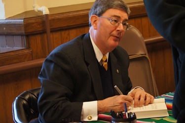 Adopt_07_George Weigel signs copies of The End and the Beginning before he speaks