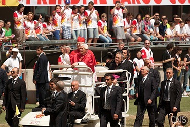 Pope Benedict XVI, flanked by Milan Cardinal Angelo Scola, waves as they arrive at San Siro stadium in Milan June 2. The pope was in Milan for the 2012 World Meeting of Families. (CNS photo/Maria Grazia Picciarella, pool) (June 4, 2012) See stories marked FAMILIES- June 1-4, 2012.
