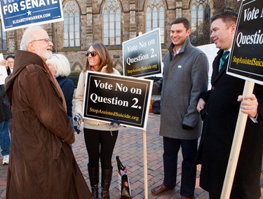 Cardinal Seán P. O’Malley greets Melanie Hebert, Esmael Ansari and Patrick Bench of the Committee Against Physician Assisted Suicide across from his polling place at Cathedral High School in Boston Nov. 6, 2012.
Pilot photo/ Gregory L. Tracy
