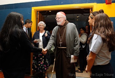 MARY SCHWALM/Staff photo Cardinal Sean P. O'Malley shakes hands with Notre Dame Cristo Rey High School students in they gym at the school after participating in 10th anniversary mass of celebration and thanksgiving at St. Mary's Church in Lawrence.   10/9/13