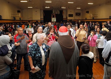 MARY SCHWALM/Staff photo Cardinal Sean P. O'Malley poses for photos for Notre Dame Cristo Rey High School students, family and friends in they gym at the school after participating in 10th anniversary mass of celebration and thanksgiving at St. Mary's Church in Lawrence.   10/9/13