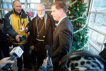 Cardinal Seán P. O'Malley, Boston Mayor-elect Marty Walsh and Sen. Edward Markey serve meals at Pine Street Inn Dec. 24, 2013. Pilot photo by Gregory L. Tracy