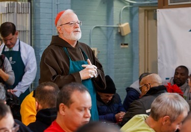 Cardinal Seán P. O'Malley, Boston Mayor-elect Marty Walsh and Sen. Edward Markey serve meals at Pine Street Inn Dec. 24, 2013. Pilot photo by Gregory L. Tracy