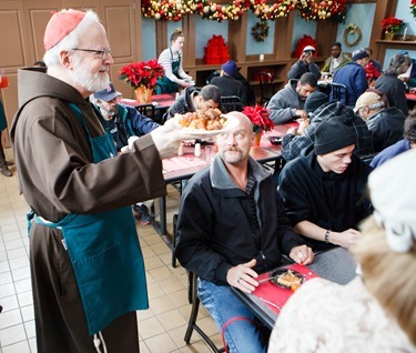 Cardinal Seán P. O'Malley, Boston Mayor-elect Marty Walsh and Sen. Edward Markey serve meals at Pine Street Inn Dec. 24, 2013. Pilot photo by Gregory L. Tracy