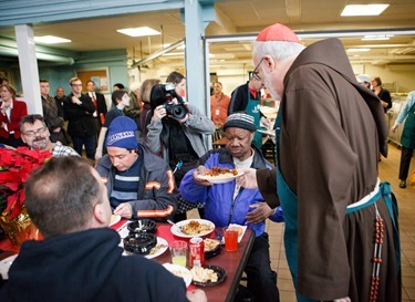 Cardinal Seán P. O'Malley, Boston Mayor-elect Marty Walsh and Sen. Edward Markey serve meals at Pine Street Inn Dec. 24, 2013. Pilot photo by Gregory L. Tracy