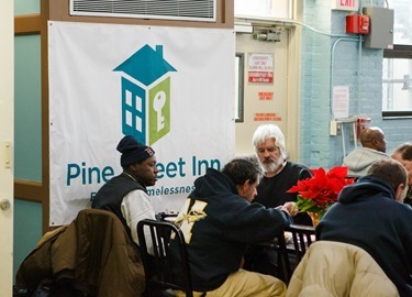 Cardinal Seán P. O'Malley, Boston Mayor-elect Marty Walsh and Sen. Edward Markey serve meals at Pine Street Inn Dec. 24, 2013. Pilot photo by Gregory L. Tracy