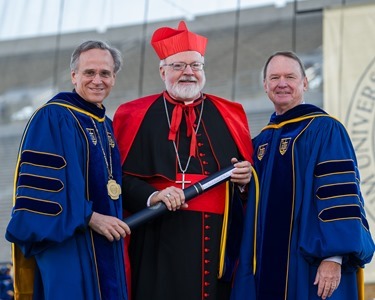 May 18, 2014; University of Notre Dame president Rev. John Jenkins, C.S.C., left, and Notre Dame Board of Trustees chairman Richard Notebaert, right, present an honorary degree to Cardinal Seán Patrick O’Malley, O.F.M. Cap. at the 2014 Commencement ceremony in Notre Dame Stadium.

Photo by Matt Cashore/University of Notre Dame