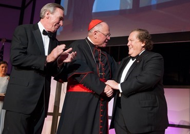 Left, John Garvey, President of CUA and Archbishop of New York, Cardinal Timothy M. Dolan presents the Cardinal's Appreciation Award to Thomas J. "Tom" Moran, right, CEO and President of Mutual of America.