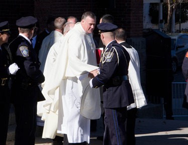 Mourners gather outside Most Precious Blood Church in Hyde Park for the Funeral Mass for former Boston mayor Thomas M. Menino Nov. 3, 2014.  The former mayor died Oct. 30 just week after announcing that he was suspending his treatment for cancer.<br />
Pilot photo/ Christopher S. Pineo<br />
