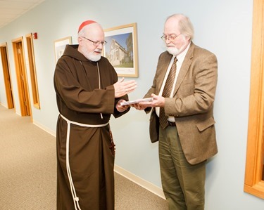 Cardinal Sean P. O'Malley is pictured with retiring archivist of the Archdiocese of Boston, Robert Johnson-Lally in the cardinal’s offices, Jan. 7, 2015. Johnson-Lally retired Dec. 31, 2014 after serving the archdiocese from more than 20 years.
Pilot photo/ Gregory L. Tracy 
