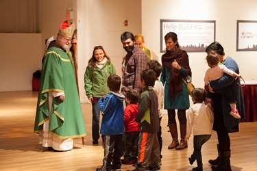 Sean Cardinal O'Malley greeting a family at New York Encounter 2015 before the celebration of mass.