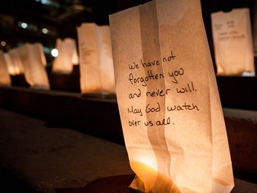 Votive candle holders with messages remembering victims of the Armenian genocide sit on the steps of the Trinity Church in Boston April 23 during an ecumenical prayer service to mark the centennial of the genocide during which 1.5 people are believed to have perished.
Pilot photo/ Gregory L. Tracy 
