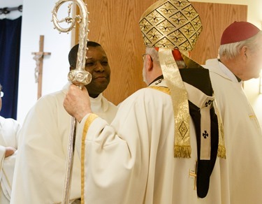 Cardinal Seán P. O'Malley formally accepts Father Garcia Brenneville as a priest of the Archdiocese of Boston in a ritual known as incardination at the archdiocese’s Pastoral Center April 7, 2015.  Father Brenneville is a native of Port-Au-Prince, Haiti, and he serves as parochial vicar at Christ the King Parish, St. Edith Stein Parish and Our Lady of Lourdes Parish in Brockton.  (Pilot photo/ Gregory L. Tracy)