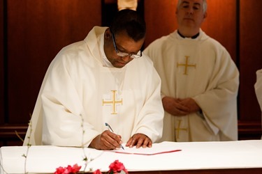 Cardinal Seán P. O'Malley formally accepts Father Garcia Brenneville as a priest of the Archdiocese of Boston in a ritual known as incardination at the archdiocese’s Pastoral Center April 7, 2015.  Father Brenneville is a native of Port-Au-Prince, Haiti, and he serves as parochial vicar at Christ the King Parish, St. Edith Stein Parish and Our Lady of Lourdes Parish in Brockton.  (Pilot photo/ Gregory L. Tracy)