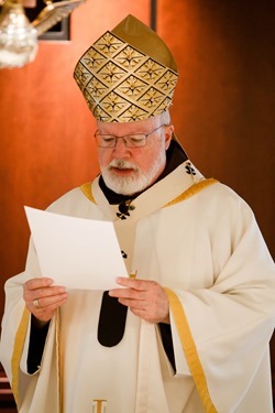 Cardinal Seán P. O'Malley formally accepts Father Garcia Brenneville as a priest of the Archdiocese of Boston in a ritual known as incardination at the archdiocese’s Pastoral Center April 7, 2015.  Father Brenneville is a native of Port-Au-Prince, Haiti, and he serves as parochial vicar at Christ the King Parish, St. Edith Stein Parish and Our Lady of Lourdes Parish in Brockton.  (Pilot photo/ Gregory L. Tracy)