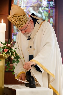 Cardinal Seán P. O'Malley formally accepts Father Garcia Brenneville as a priest of the Archdiocese of Boston in a ritual known as incardination at the archdiocese’s Pastoral Center April 7, 2015.  Father Brenneville is a native of Port-Au-Prince, Haiti, and he serves as parochial vicar at Christ the King Parish, St. Edith Stein Parish and Our Lady of Lourdes Parish in Brockton.  (Pilot photo/ Gregory L. Tracy)