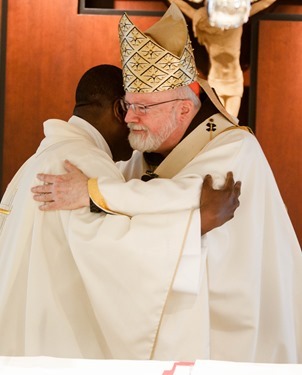 Cardinal Seán P. O'Malley formally accepts Father Garcia Brenneville as a priest of the Archdiocese of Boston in a ritual known as incardination at the archdiocese’s Pastoral Center April 7, 2015.  Father Brenneville is a native of Port-Au-Prince, Haiti, and he serves as parochial vicar at Christ the King Parish, St. Edith Stein Parish and Our Lady of Lourdes Parish in Brockton.  (Pilot photo/ Gregory L. Tracy)