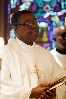 Cardinal Seán P. O'Malley formally accepts Father Garcia Brenneville as a priest of the Archdiocese of Boston in a ritual known as incardination at the archdiocese’s Pastoral Center April 7, 2015.  Father Brenneville is a native of Port-Au-Prince, Haiti, and he serves as parochial vicar at Christ the King Parish, St. Edith Stein Parish and Our Lady of Lourdes Parish in Brockton.  (Pilot photo/ Gregory L. Tracy)