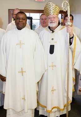 Cardinal Seán P. O'Malley formally accepts Father Garcia Brenneville as a priest of the Archdiocese of Boston in a ritual known as incardination at the archdiocese’s Pastoral Center April 7, 2015.  Father Brenneville is a native of Port-Au-Prince, Haiti, and he serves as parochial vicar at Christ the King Parish, St. Edith Stein Parish and Our Lady of Lourdes Parish in Brockton.  (Pilot photo/ Gregory L. Tracy)