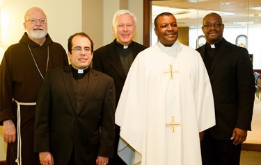 Cardinal Seán P. O'Malley formally accepts Father Garcia Brenneville as a priest of the Archdiocese of Boston in a ritual known as incardination at the archdiocese’s Pastoral Center April 7, 2015.  Father Brenneville is a native of Port-Au-Prince, Haiti, and he serves as parochial vicar at Christ the King Parish, St. Edith Stein Parish and Our Lady of Lourdes Parish in Brockton.  (Pilot photo/ Gregory L. Tracy)