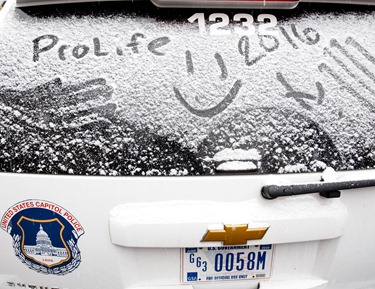 A prolife message is written on the on the snow-covered window of a U.S. Capitol Police patrol car parked front of the U.S. Supreme Court during the 2016 March for Life Jan. 22. Pilot photo/ Gregory L. Tracy 