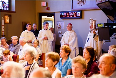 Bishops-elect Robert Reed and Mark O’Connell take their Oath of Fidelity before Cardinal O’Malley during a Mass broadcast live on CatholicTV Aug. 12, 2016. During the Mass, the cardinal also blessed the insignia — crossiers, mitres and rings — that the bishops will receive at their ordination.
Pilot photo/ Gregory L. Tracy 
