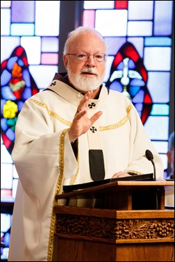 Bishops-elect Robert Reed and Mark O’Connell take their Oath of Fidelity before Cardinal O’Malley during a Mass broadcast live on CatholicTV Aug. 12, 2016. During the Mass, the cardinal also blessed the insignia — crossiers, mitres and rings — that the bishops will receive at their ordination.
Pilot photo/ Gregory L. Tracy 
