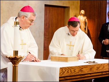 Bishops-elect Robert Reed and Mark O’Connell take their Oath of Fidelity before Cardinal O’Malley during a Mass broadcast live on CatholicTV Aug. 12, 2016. During the Mass, the cardinal also blessed the insignia — crossiers, mitres and rings — that the bishops will receive at their ordination.
Pilot photo/ Gregory L. Tracy 
