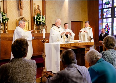 Bishops-elect Robert Reed and Mark O’Connell take their Oath of Fidelity before Cardinal O’Malley during a Mass broadcast live on CatholicTV Aug. 12, 2016. During the Mass, the cardinal also blessed the insignia — crossiers, mitres and rings — that the bishops will receive at their ordination.
Pilot photo/ Gregory L. Tracy 
