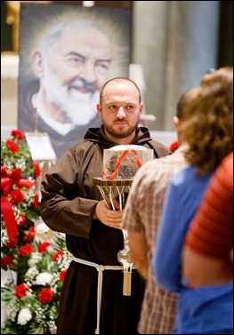 The faithful venerate the relic of the heart of St. Padre Pio at Immaculate Conception Church in Lowell, Mass. Sept 21, 2016. The relic is on a three-day tour of the Archdiocese of Boston, which will culminate with a Mass celebrated by Cardinal Seán P. O'Malley on the saint’s feast day, Sept. 23. Pilot photo/ Gregory L. Tracy 