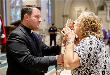 A woman venerates the relic of the heart of St. Padre Pio at Immaculate Conception Church in Lowell, Mass. The church was the first stop in a Sept. 21 – 23 tour of the relic to the Boston area. This trip marks the first time a major relic of St. Padre Pio has travelled outside Italy. Pilot photo/ Gregory L. Tracy 