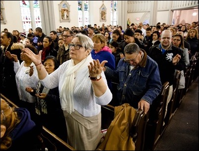 Cardinal Seán P. O'Malley celebrates Mass at Most Holy Redeemer Parish in East Boston Sunday, Feb. 5, 2017. Before the Mass the cardinal, Boston Mayor Martin Walsh and Police Commissioner William Evans addressed the congregation expressing support for the city’s immigrant community. Pilot photo/ Gregory L. Tracy 