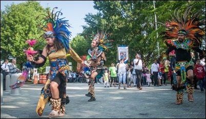 Hispanic dancers whirl in vibrant costumes, dancing to the Virgin of Guadalupe as the Saturday morning procession begins for the 2018 Eucharistic Congress. This group was one of several dance troupes from churches around the archdiocese. Photo by Thomas Spink