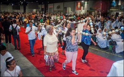 Parishioners representing the Alpharetta parish of St. Thomas Aquinas process into the hall with an eye-catching rosary. Photo by Thomas Spink