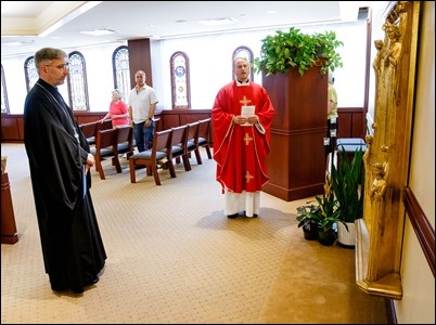 Father Demetri Tonias, representative of the Greek Orthodox Metropolitan of Boston, attends the Mass celebrated by Father Daniel Hennessey on the Feast of the Sts. Peter and Paul at the Archdiocese of Boston’s Pastoral Center in Braintree, June 29, 2018. For almost 30 years the Catholic and Greek Orthodox communities of Boston have followed the practice of exchanging delegations on the feast days of their patron saints. Pilot photo/ Gregory L. Tracy