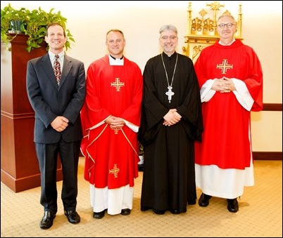 Father Demetri Tonias, representative of the Greek Orthodox Metropolitan of Boston, attends the Mass celebrated by Father Daniel Hennessey on the Feast of the Sts. Peter and Paul at the Archdiocese of Boston’s Pastoral Center in Braintree, June 29, 2018. For almost 30 years the Catholic and Greek Orthodox communities of Boston have followed the practice of exchanging delegations on the feast days of their patron saints. Pilot photo/ Gregory L. Tracy